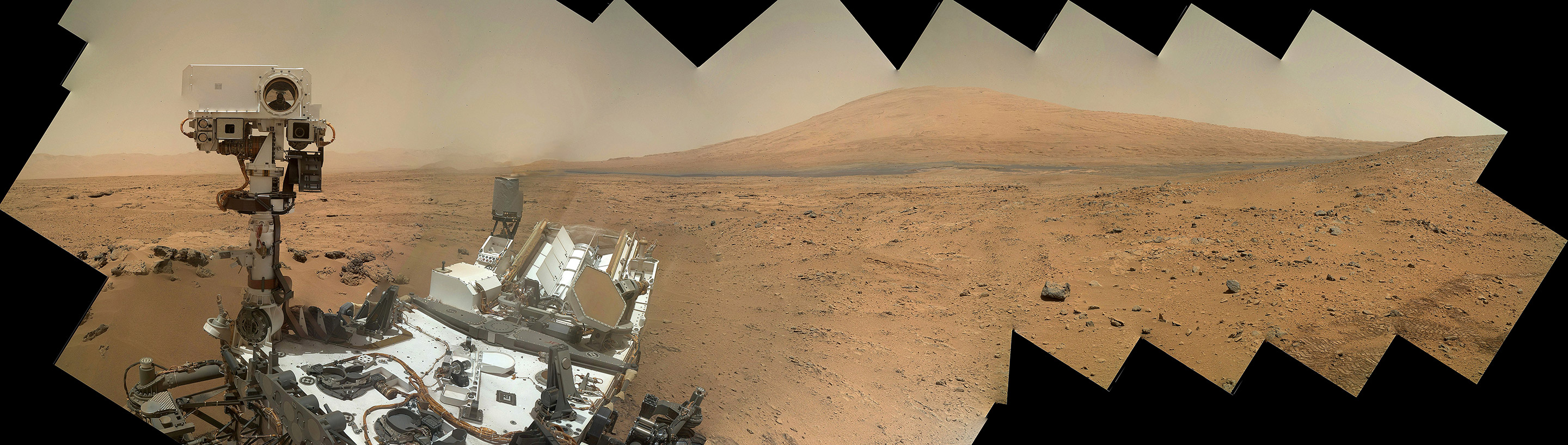 Curiosity snaps a self portrait with Mount Sharp in the background at Rocknest ripple in Gale Crater on Sol 85 using the Mars Hand Lens Imager (MAHLI) camera on the robotic arm. This color mosaic was assembled from raw images taken Nov. 1, 2012.Credit: NASA/JPL-Caltech/MSSS/Ken Kremer/Marco Di Lorenzo