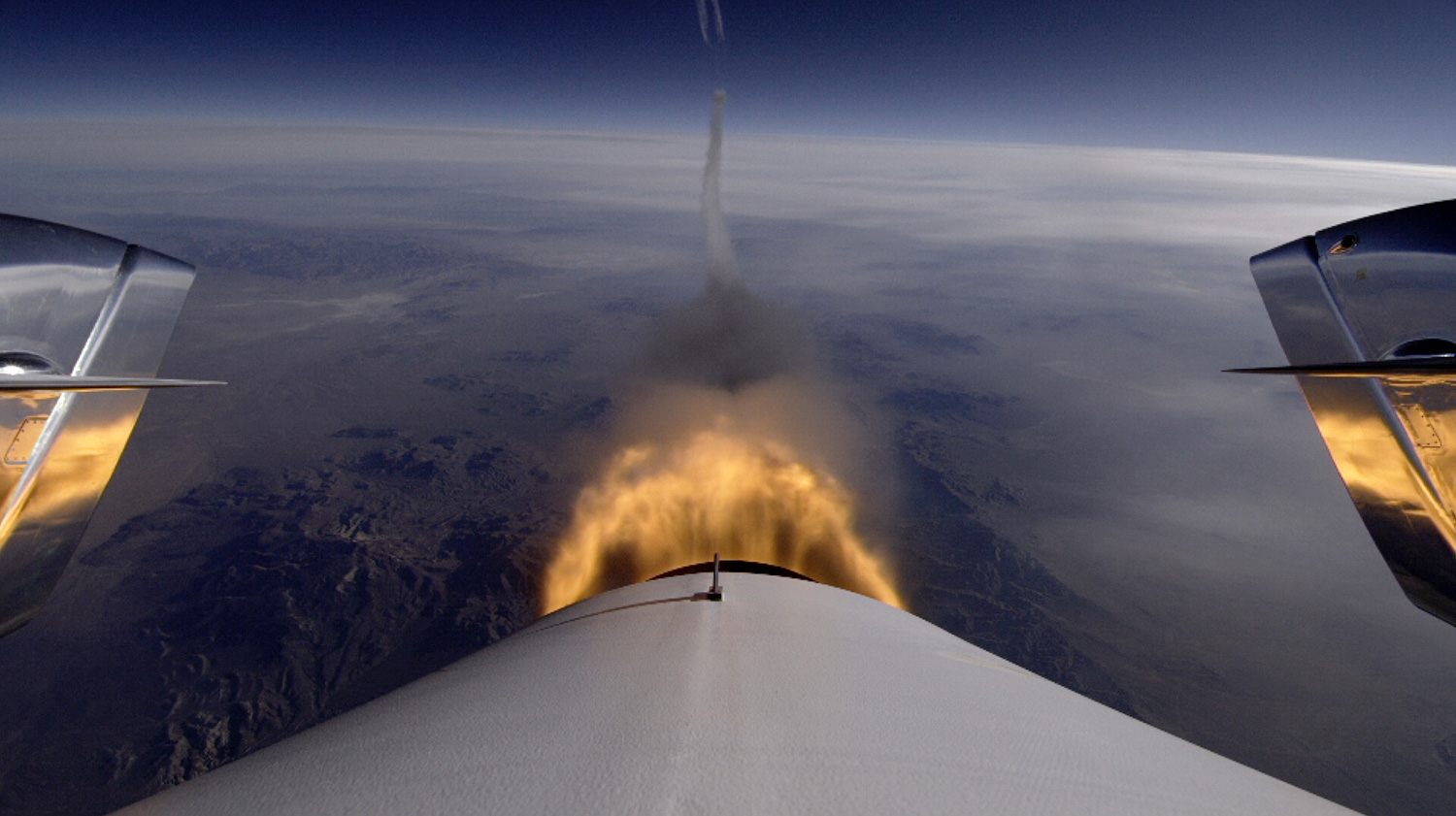 Tail-cam view of the hybrid engine burning during a test flight of SpaceShipTwo which saw the vehicle ascend to 71,000 feet over the Mojave Desert. Credit: Virgin Galactic