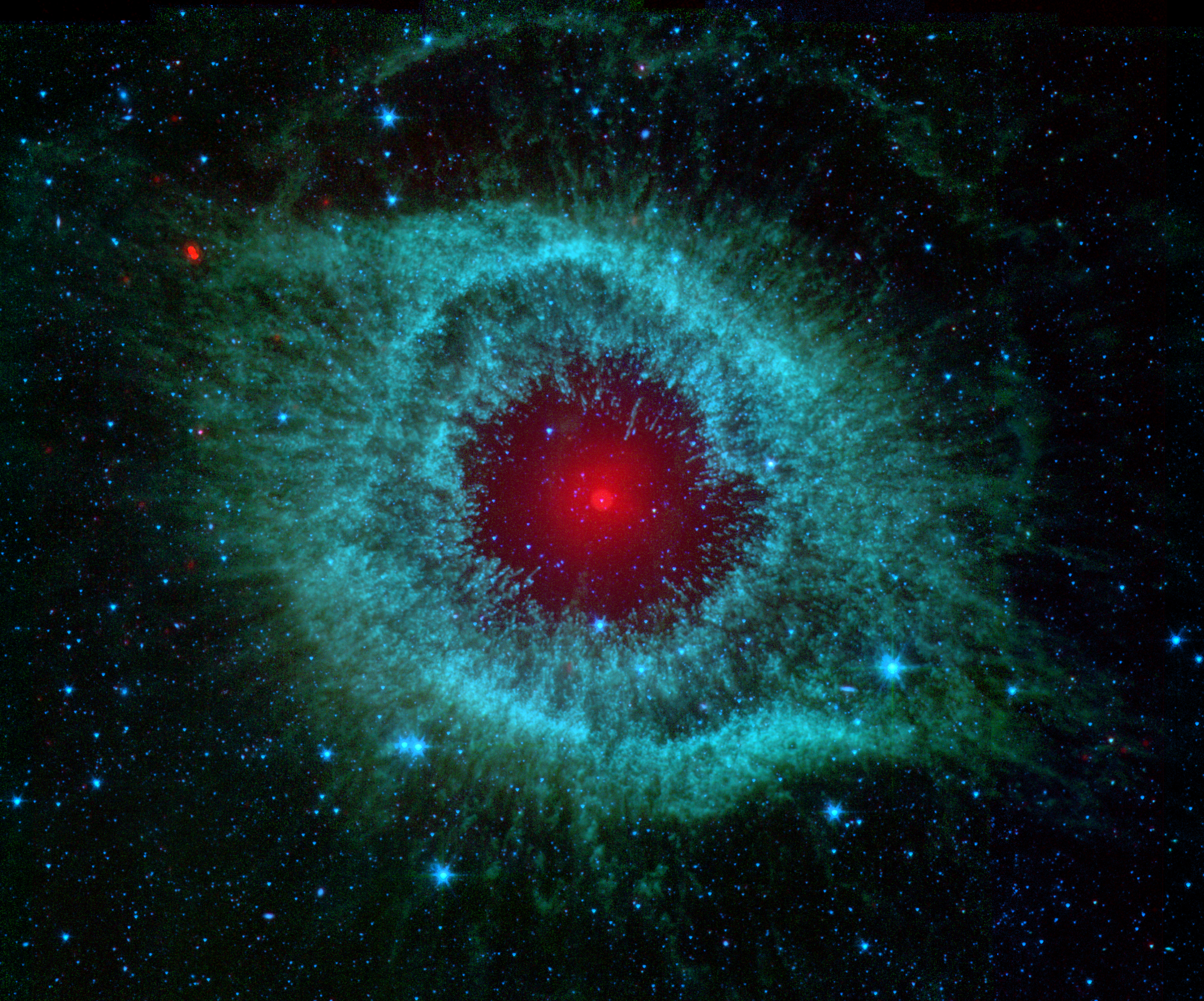 Helix Nebula: Some say Spitzer’s infrared view of the Helix nebula - a dying star and its scattered remains - resembles the eye a green monster. Credit: NASA/JPL-Caltech/Univ.of Ariz.