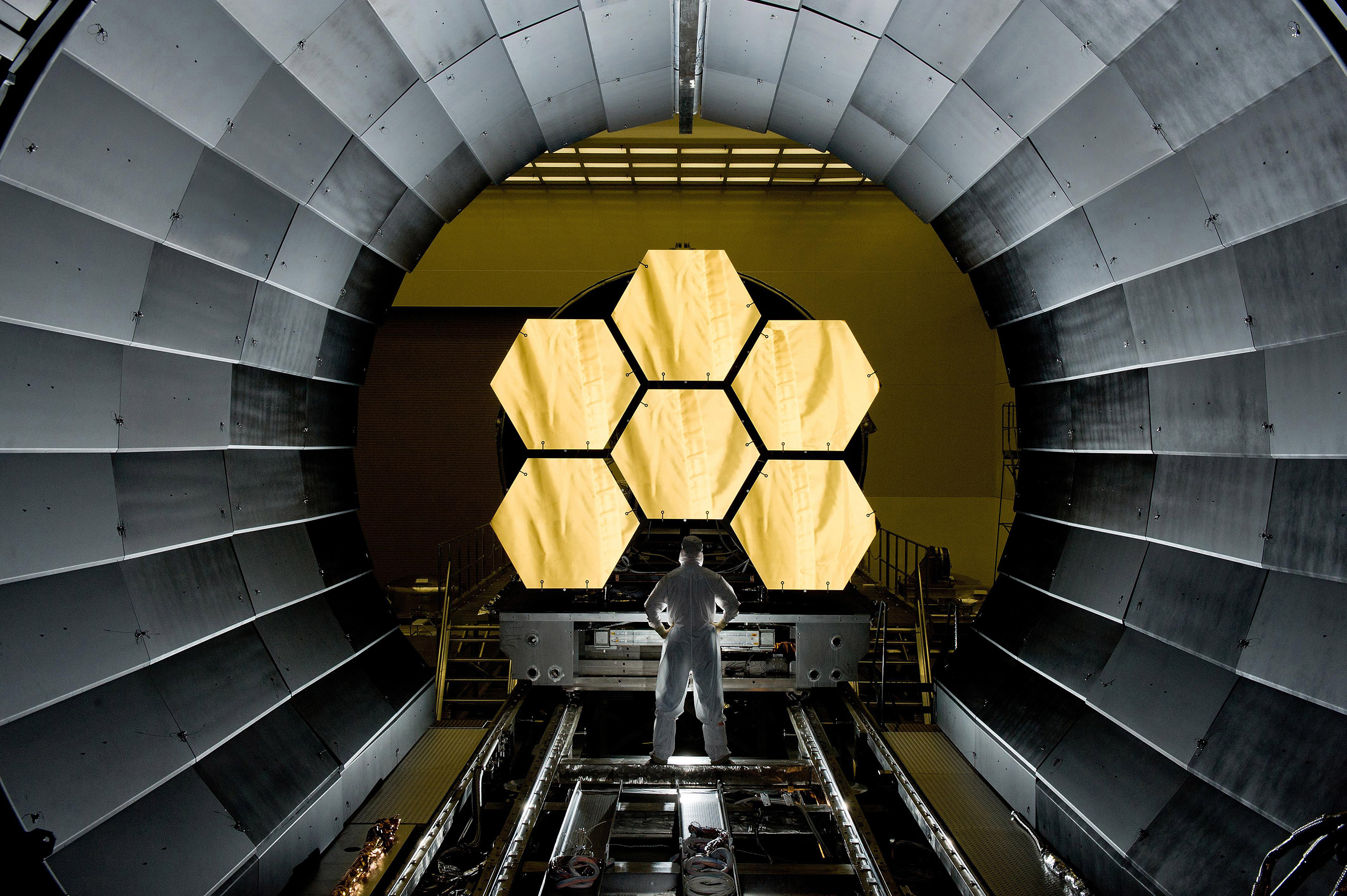 NASA engineer Ernie Wright looks on as the first six flight ready James Webb Space Telescope’s primary mirror segments are prepped to begin final cryogenic testing at NASA’s Marshall Space Flight Center. This represents the first six of 18 segments that will form the telescope’s primary mirror. Photo: NASA/MSFC/David Higginbotham