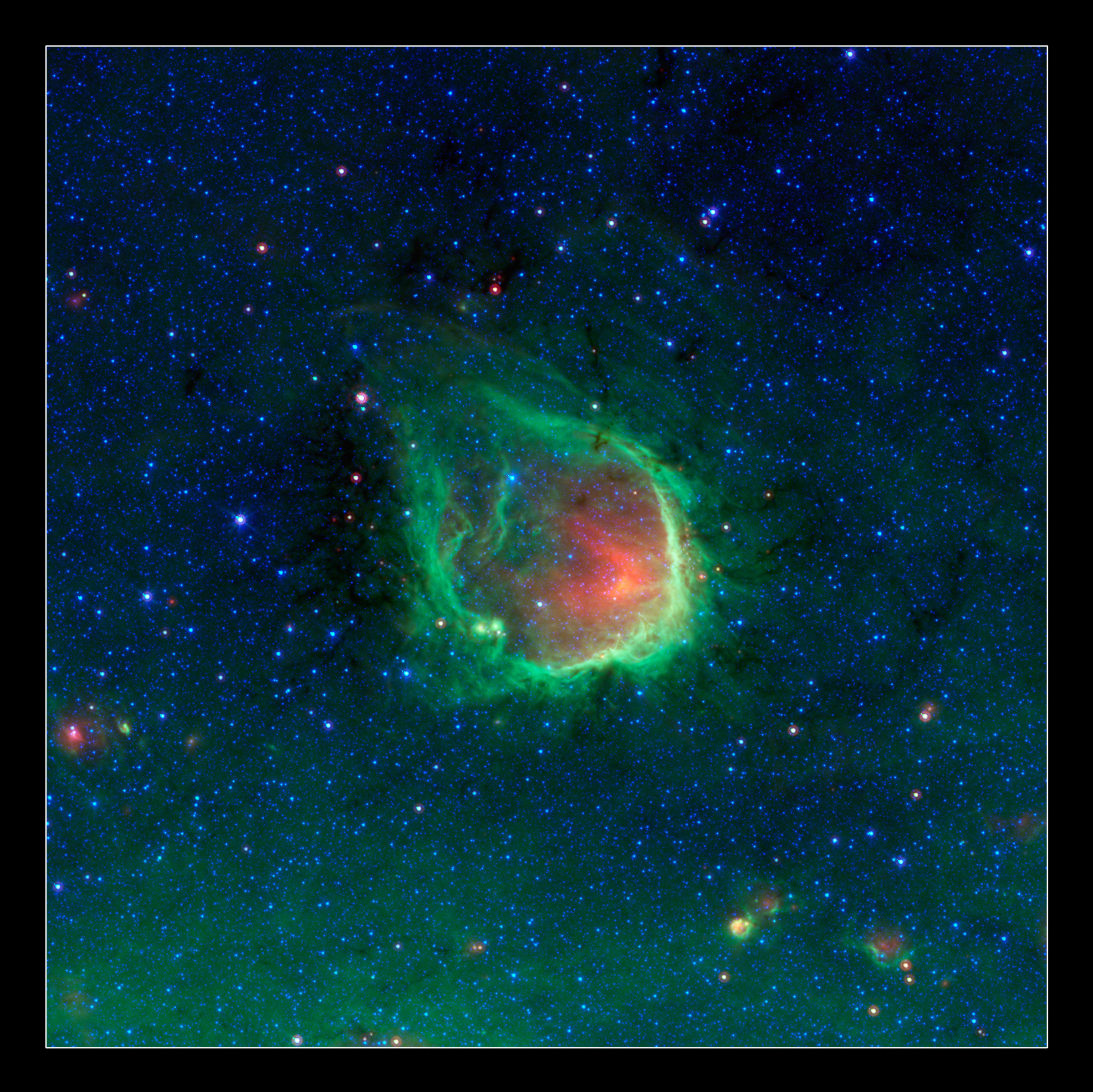 This glowing emerald nebula seen by Spitzer is reminiscent of the glowing ring wielded by the superhero Green Lantern. Astronomers believe rings like this are actually sculpted by the powerful light of giant “O” stars. Named RCW 120 by astronomers, this region of hot gas and glowing dust can be found in the constellation Scorpius. Image: NASA/JPL-Caltech/GLIMPSE-MIPSGAL Teams