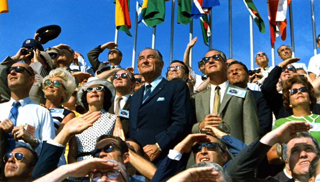 Vice President Spiro Agnew (gray blazer) and former President Lyndon B. Johnson (blue suit) view the liftoff of Apollo 11.