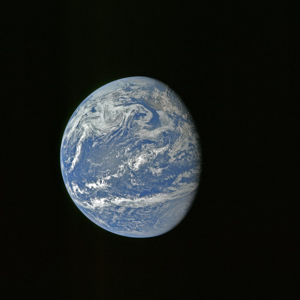 Earth is captured through the astronauts’ camera during the translunar journey toward the Moon. 
