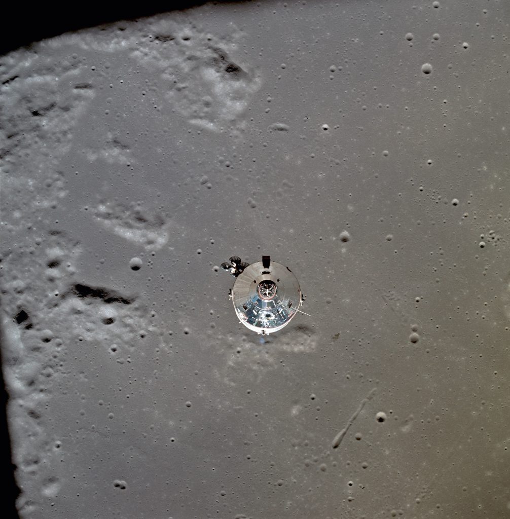 The CM seen orbiting the Moon just after separation of the LM. The lunar surface below is in the north central Sea of Fertility approximately 125 km below the spacecraft..
