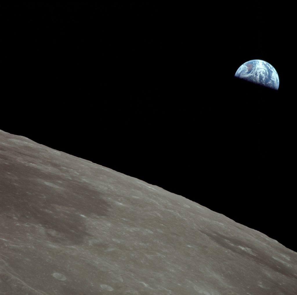 A half-eclipsed Earth as seen from the Moon’s orbit during the Apollo 11 mission.