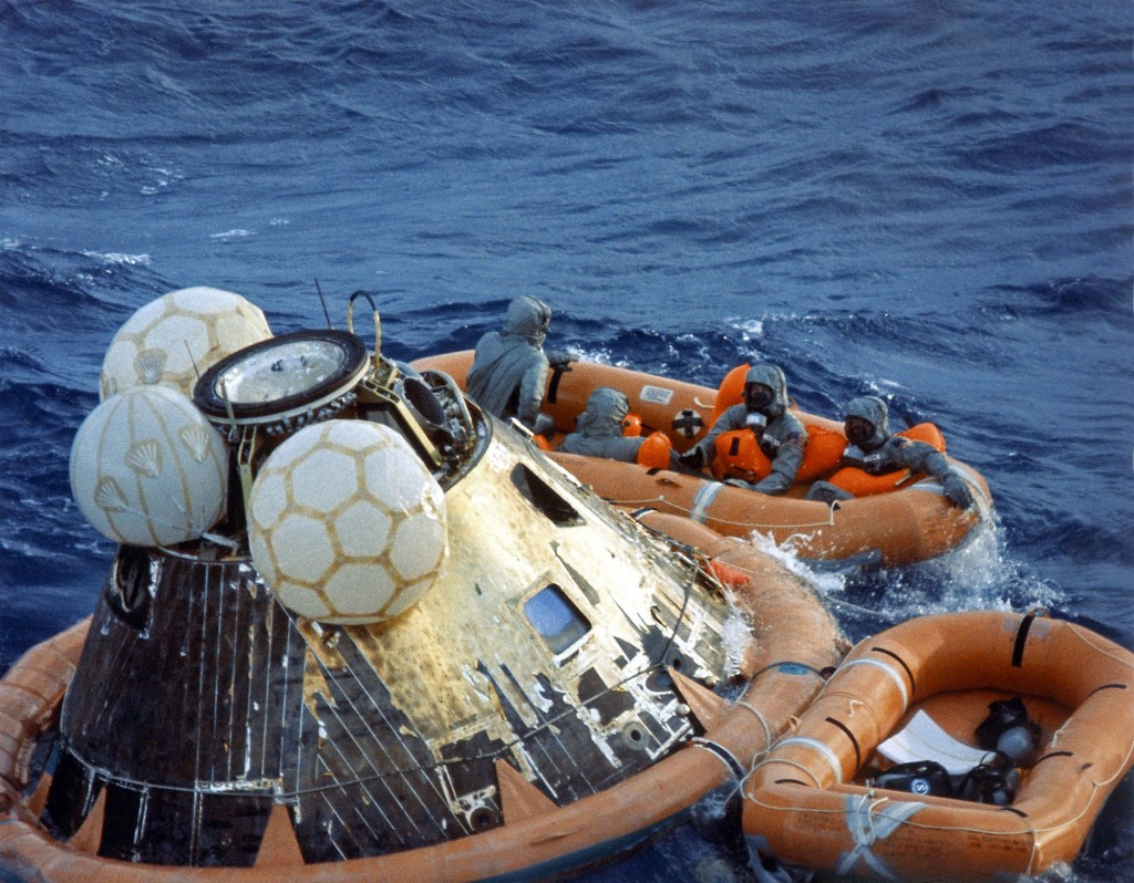 The Apollo 11 crewmen await pickup by a helicopter from the U.S.S. Hornet after splashing down at 11:40 a.m., July 24, 1969, about 812 nautical miles southwest of Hawaii.