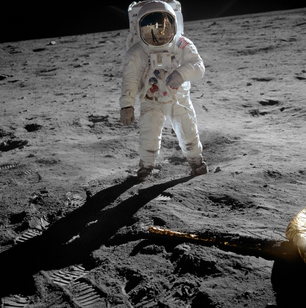 Edwin ‘Buzz’ Aldrin walks on the lunar surface. The plexiglass of his helmet reflects back the scene in front of him, including Neil Armstrong taking his picture.