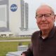Jack King stands outside the KSC Press Center with the VAB in the background. Credit: Nicole Solomon