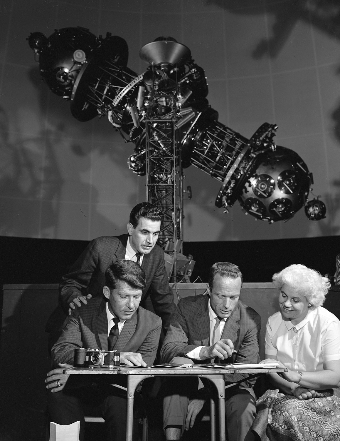 Wally Schirra and Scott Carpenter (sitting) get some help while studying star charts at Morehead Planetarium. Credit: NASA via Retro Space Images.