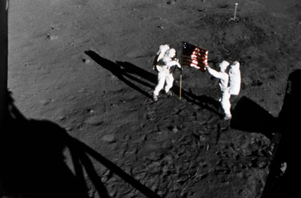 Armstrong and Aldrin deploy the American flag outside near the Lunar Module at Tranquility Base in the Sea of Tranquility on July 20, 1969.
