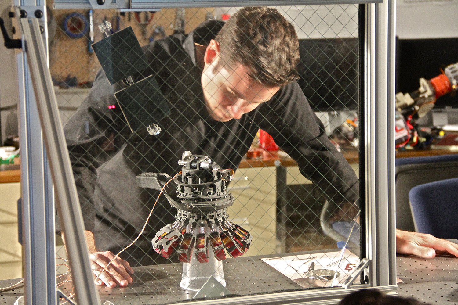 Jet Propulsion Laboratory – Group Leader, Aaron Parness working in his lab with a robotic microspine anchor 1. Credit: Rachael Joy/Science Channel