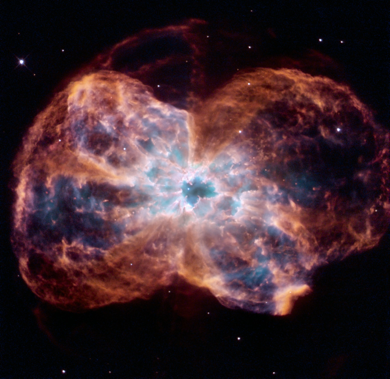 This image of NGC 2440 shows the colourful “last hurrah” of a star like our Sun. The star is ending its life by casting off its outer layers of gas, which formed a cocoon around the star’s remaining core. Ultraviolet light from the dying star makes the material glow. The burned-out star, called a white dwarf, is the white dot in the centre. Credit: NASA, ESA, and K. Noll (STScI)