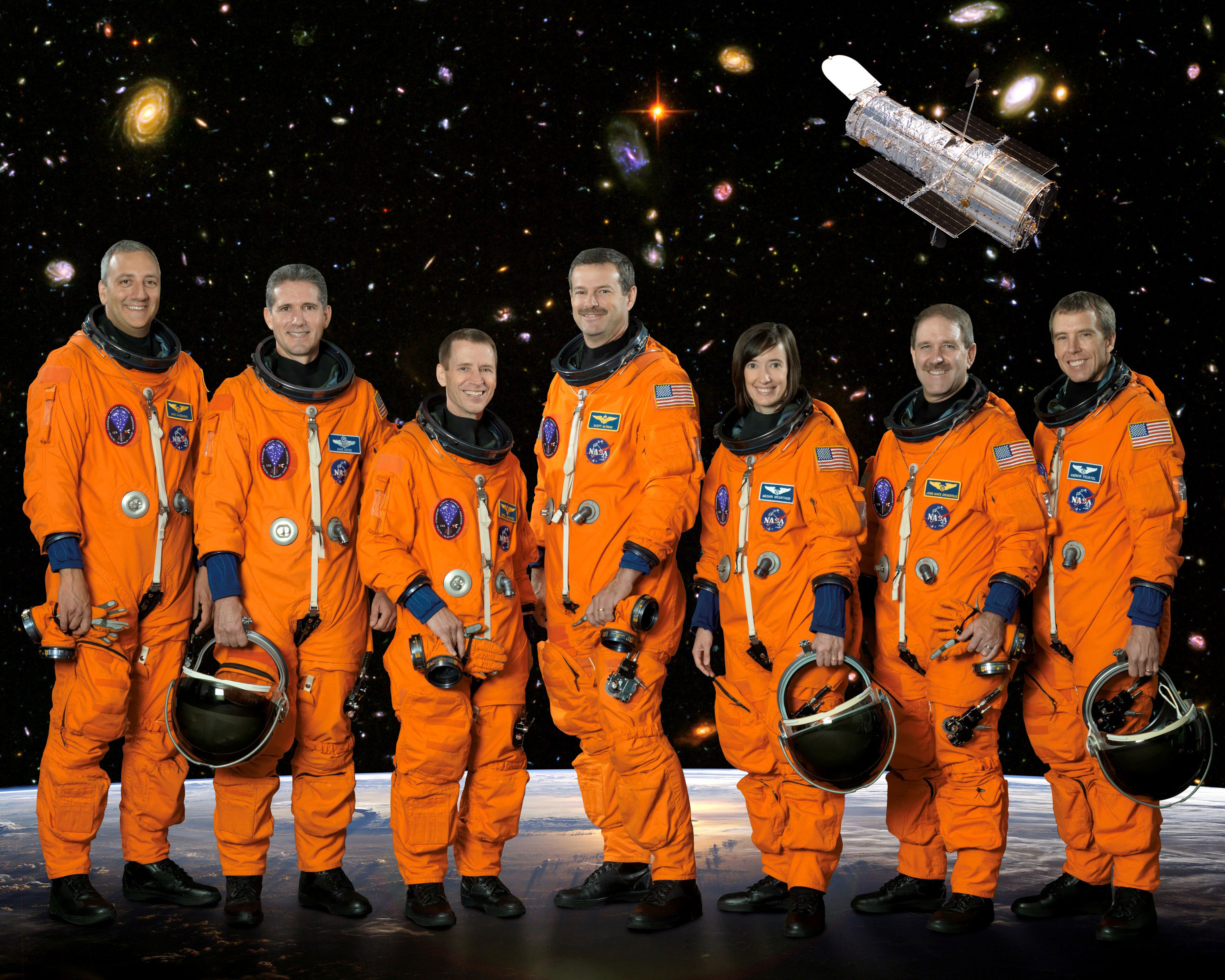 Posing for the STS-125 crew portrait, from left, are astronauts Michael J. Massimino, Michael T. Good, both mission specialists; Gregory C. Johnson, pilot; Scott D. Altman, commander; K. Megan McArthur, John M. Grunsfeld and Andrew J. Feustel, all mission specialists. The STS-125 mission was the final Space Shuttle mission to visit the Hubble Space Telescope for repairs and upgrades. Credit: NASA