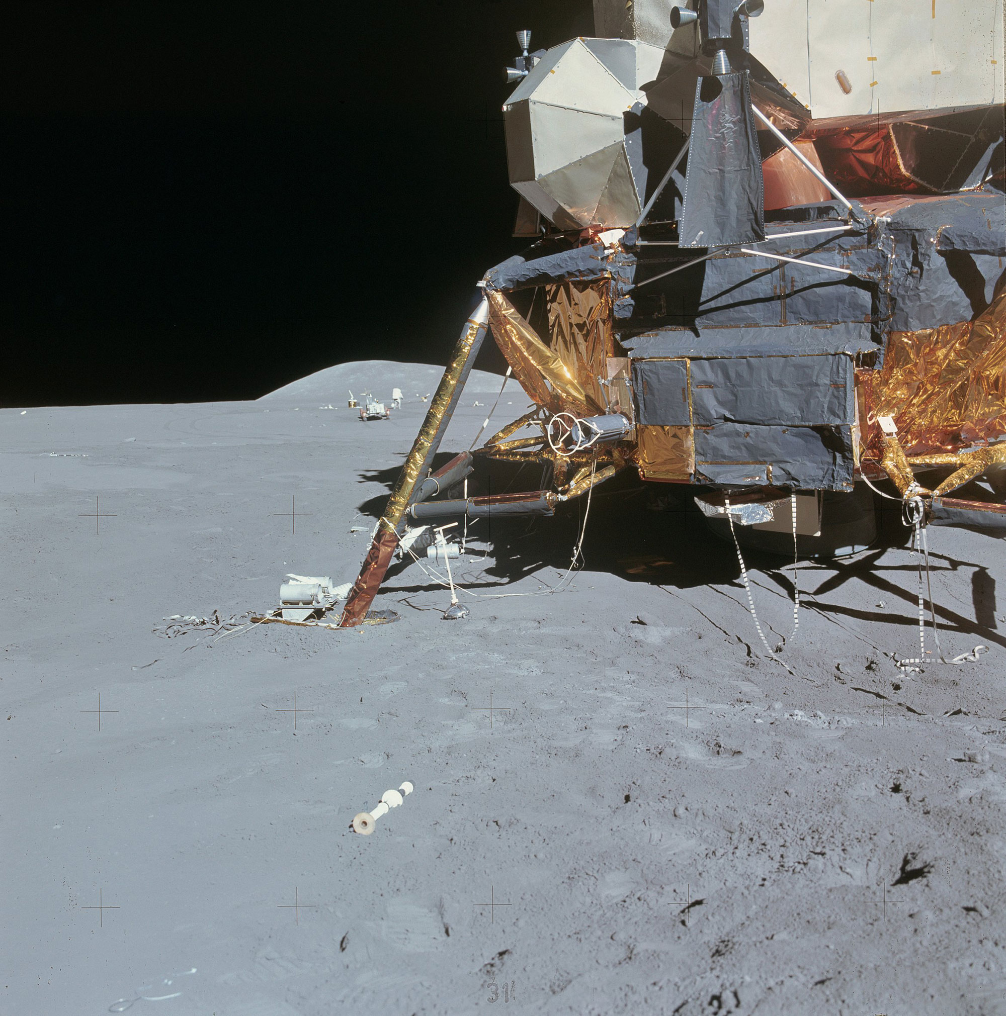 Lunar Module Falcon with the Lunar Rover seen behind its left side off in the distance. Credit: NASA via Retro Space Images