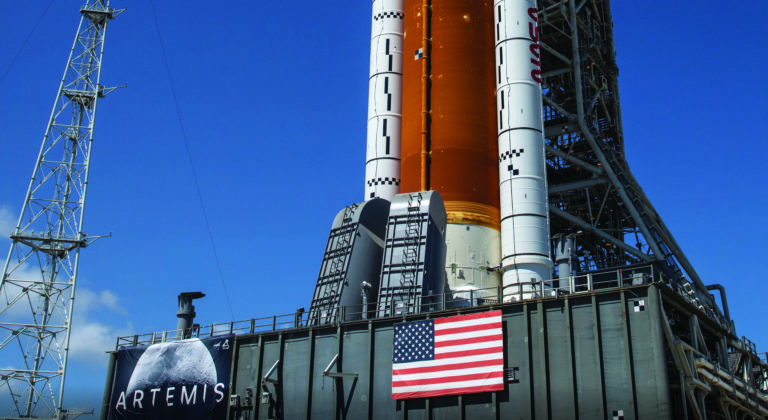 View of lower half of NASA SLS rocket atop Mobile Launch Platform